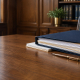 Organised family court case papers, a navy folder and a gold pen on a wooden desk, illustrating Form C1A safeguarding and domestic abuse evidence preparation.