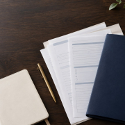 Organised family court paperwork and navy case folder on a desk, representing a respondent preparing Form C7 and C1A.